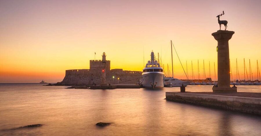 Faliraki: Evening RIB Cruise with Champagne and Sunset Views - Secluded bays and the view toward Rhodes Town