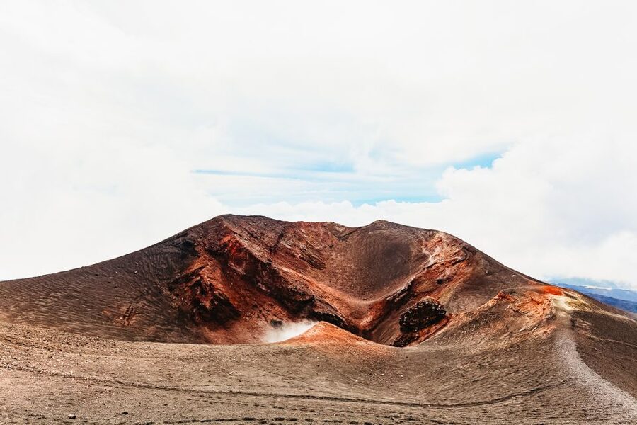 From Catania: Mt. Etna, Wine and Alcantara Tour - Entering a lava cave with a helmet lamp