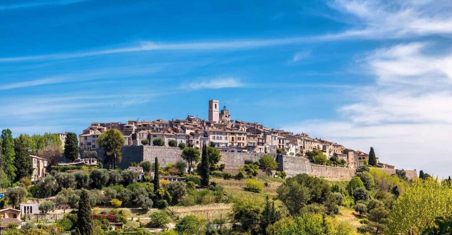 From Nice: Cannes, Saint Paul de Vence and Wine Tasting - Antibes: market stalls, old walls, and serious yachts
