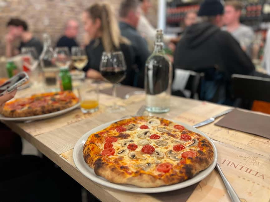 Naples: Pizza and tiramisu making class with unlimited wine - Eating your pizza with wine and soft drinks