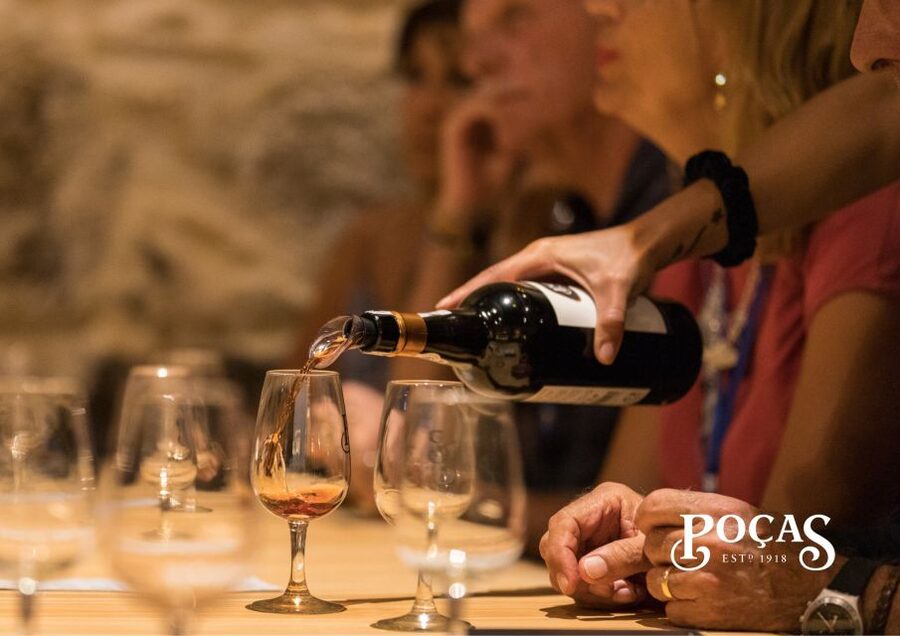 Poças: Guided Tour & Port Wine Tasting with Pastel de Nata - Entering a cellar with more than a century of Port