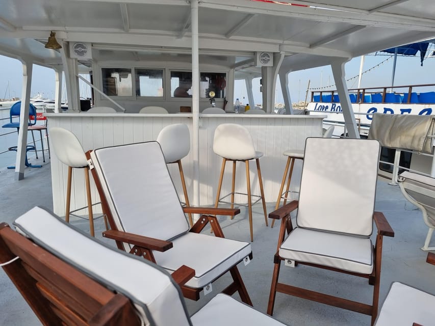 Rhodes: Sunset Cruise with Live Music, Wine & Greek Buffet - Leaving Mandraki with Rhodes behind you