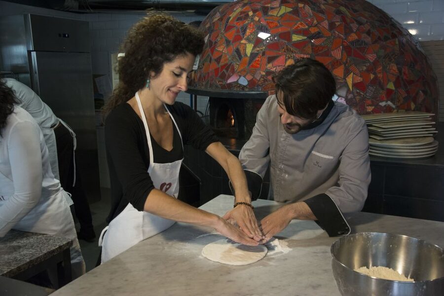 Rome: Hands-On Pizza Making Class near the Vatican with Wine - Putting your pizza in the oven