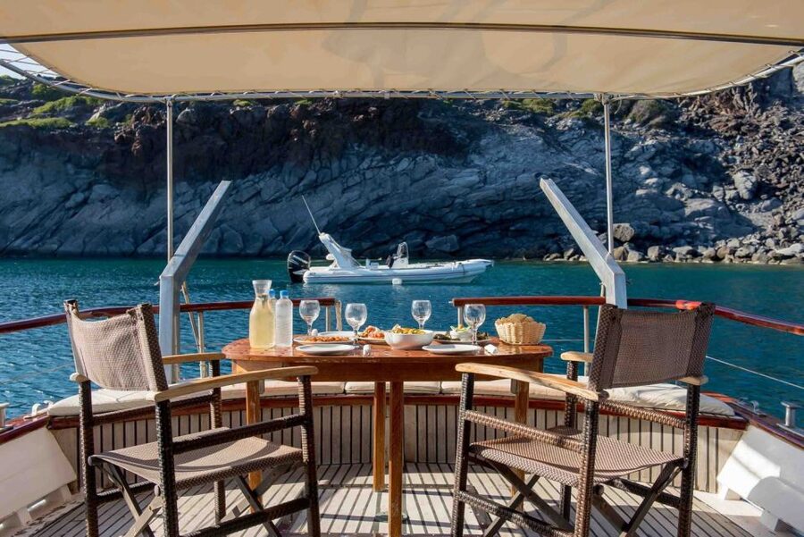 Santorini: Traditional Wooden Boat Tour with Meal and Wine - Eating Greek food on the water