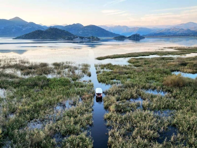 Skadar Lake: Guided Sunset Boat Tour with Wooden Boat & Wine - Three islands, reeds, and lotus flowers