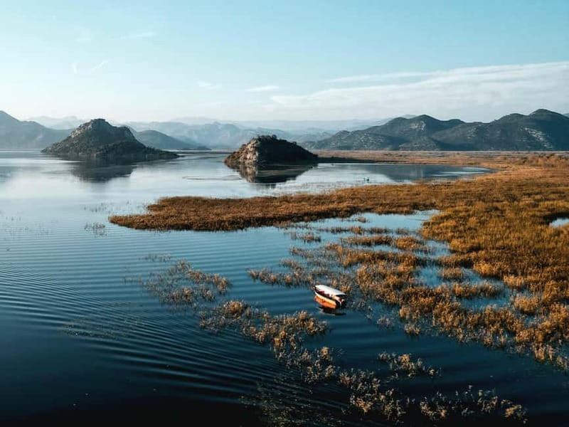 Skadar Lake: Guided Sunset Boat Tour with Wooden Boat & Wine - The swimming stop is a useful surprise